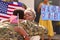 Multi-Generation Family With Parents And Wife Welcoming Army Soldier Home On Leave With Banner