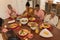 Multi-generation family praying together before having meal