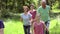 Multi-Generation Family Running Along Woodland Path Together