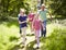 Multi Generation Family Running Through Summer Countryside