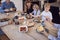 Multi-Generation Family Sitting Around Table At Home In Pyjamas Enjoying Brunch Together