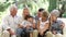 Multi Generation Family Sitting On Sofa At Home