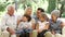 Multi Generation Family Sitting On Sofa At Home