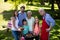 Multi generation family standing near the barbeque in park