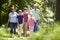 Multi Generation Family Walking Through Summer Countryside