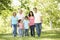 Multi Generation Hispanic Family Walking In Park