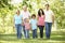 Multi Generation Hispanic Family Walking In Park