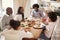 Multi generation mixed race family eating their Sunday dinner together at home, elevated view