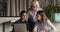 Multi-generational diverse female colleagues working on project using laptop