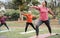 Multi generational people doing yoga class keeping at city park - Focus on right girl face