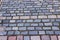 Multi-hued bricks make up a varied pattern where many feet have trod.