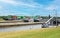 Multi lane passage lock sluice dutch facility at river Mass, container cargo ship and boats