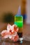 Multi-layered burning cocktail decorated with flowers on wooden table.