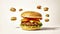 Multi-layered delicious burger with appetizing cutlet, lettuce leaf, slices of tomatoes, melted cheese in browned bun sprinkled