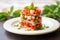 multi-layered shrimp bruschetta stacked on a square plate