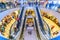 multi-level network of escalators in the Trade House `Aurora Mall`. The citizens walk, rest and make purchases. Text in Russian: