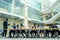 Multi Nationality of business people : indian, korean, afro-american and caucasian stand on the stairs in a modern