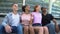 Multi-racial group young people hugging sitting outdoors friendship togetherness