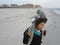 Multi Racial tween girl on beach by ocean