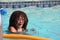 Multi Racial tween girl in pool with goggles on