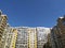 A multi-storey house against a blue sky. A new modern apartment building with glass balconies. Residential area. Realty. Copy