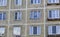 A multi-storey residential building of the Soviet period. Gray faceless windows and walls. Russia.