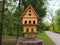 Multi-storey wooden carved birdhouse on a tree stump, a feeder for birds