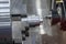 The multi-tasking CNC lathe machine  chamfer cutting the metal shaft parts by milling turret