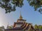 The multi tiered roof of a building at a Thai temple