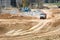 Multi-ton heavy mining dump truck loaded with cargo during removal of construction soil from construction site. Concept