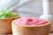 Multicolor Aromatherapy Salt in Wooden Bowl with Herbal Compress close upSerene Spa Setting