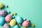 Multicolor Easter eggs on mint background