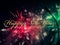 Multicolor fireworks explosion at night with Happy new year greeting text