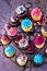 Multicolor frosting and sprinkles on cupcakes on three tier stand