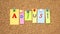 Multicolor notes with letters pinned on a cork board. Word ADJUST