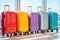 Multicolor packed suitcases on airport background. Travel concept