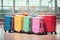 Multicolor packed suitcases on airport background. Travel concept