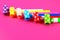 Multicolor party blowers on pink background. Multicolored party whistles. Decor for a birthday