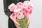 Multicolor pink buttercup, Ranunculus in a vase in woman hand. the work of the florist at a flower shop .