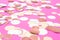 Multicolor pink, gold and white confetti on the bright pink background, holiday celebration backdrop