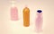 Multicolor plastic refillable liquid toiletry product containers in row, bottles