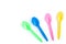 Multicolor plastic spoons on white background