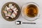 Multicolor rakhat-lukum in saucer, cup of tea, teaspoon