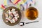 Multicolor rakhat-lukum in saucer, tea, teaspoon, napkin on table