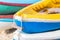 Multicolor rowboat or sea kayaks on beach with copy space.