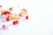 Multicolor tablets and pills over white background with copy space. Assorted various medicine capsules, pills and drugs