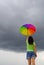 Multicolor umbrella woman against the rain