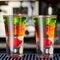 Multicolored alcoholic drinks shots on the bar counter