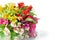 Multicolored alstroemeria flowers bouquet on white mirror background in water drops isolated close up