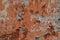 Multicolored background:concrete surface with peeling and cracked brown paint Natural defects Scratches cracks crevices chips dust